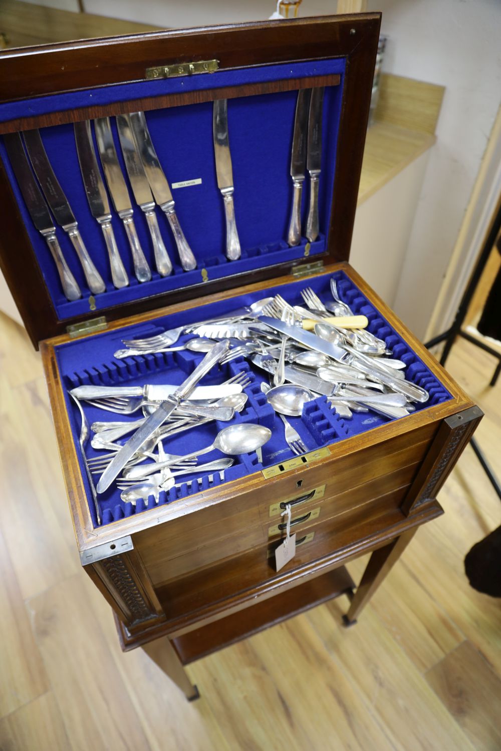 A mahogany cased canteen of cutlery and stand